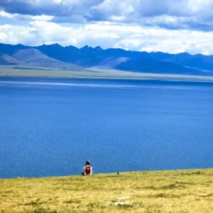 Namtso Lake shoreline with turquoise water and mountains in Tibet