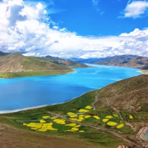 Sacred turquoise Yamdrok Lake winding through Tibetan mountains