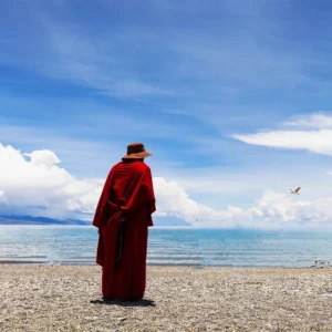 Sacred Namtso Lake shoreline under blue sky in Tibet