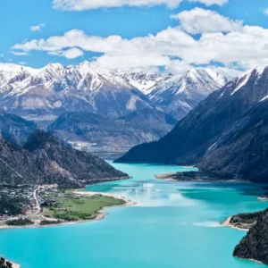 Turquoise Ranwu Lake surrounded by snow mountains in Tibet